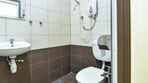 A bathroom with a sink, toilet, and shower.