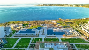 An aerial view of a resort with multiple swimming pools, a marina, and a coastal landscape. - Anda Barut Collection - Ultra All Inclusive (Didim)