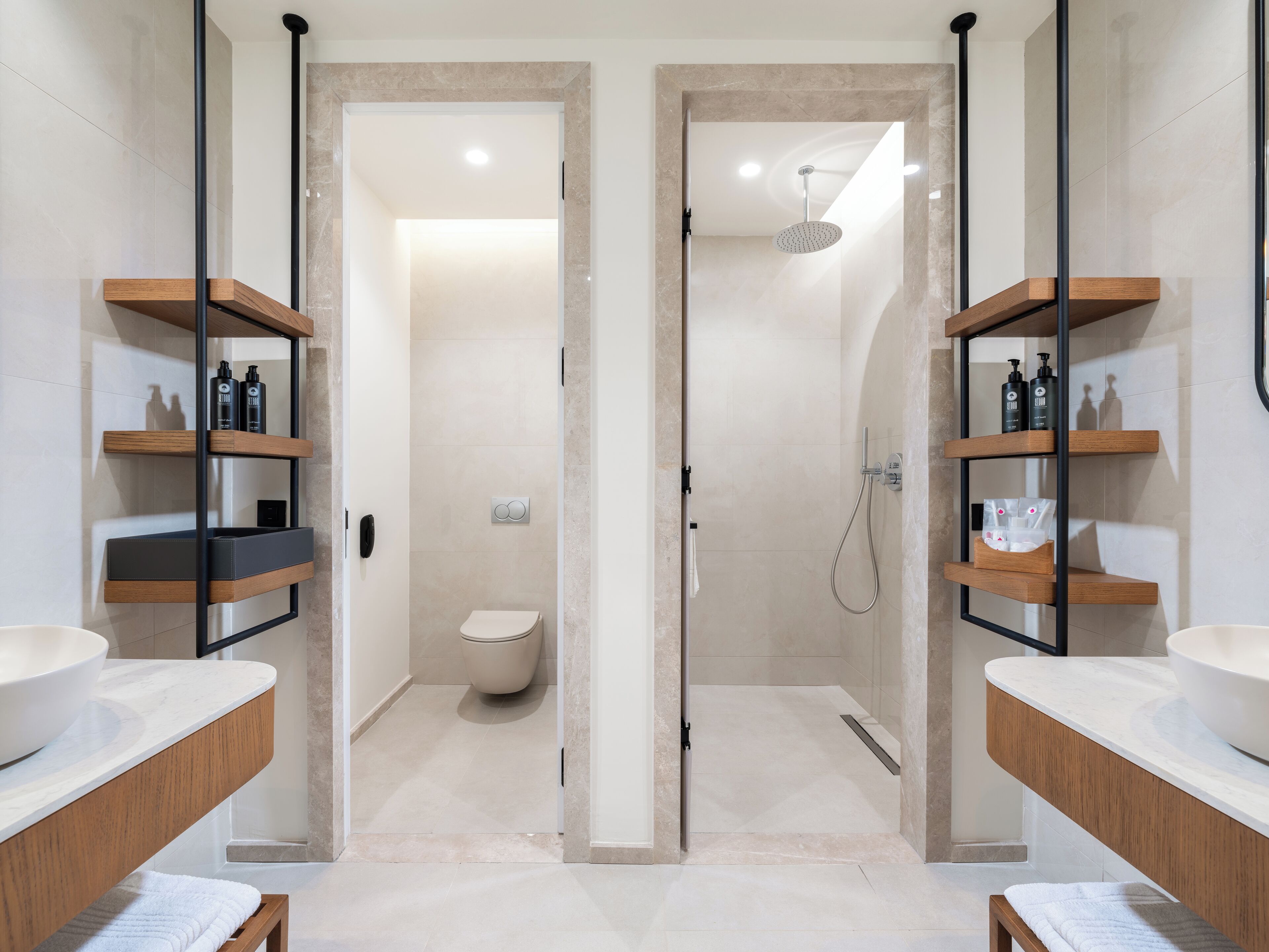 A modern bathroom with two sinks, wooden shelves, and a shower area.