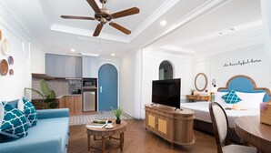Un espacio habitable compacto con kitchenette, comedor y dormitorio.