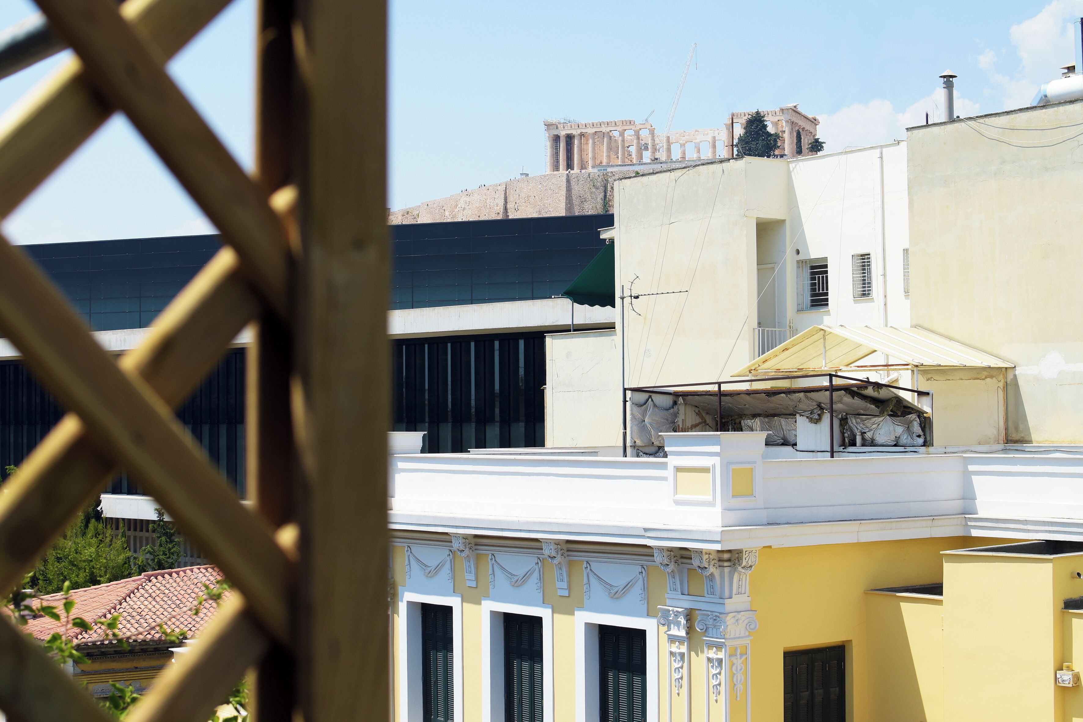 A view of a building with classical architectural elements, including columns and a balcony.