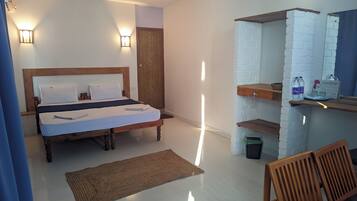 A neatly arranged bedroom with a wooden bed, a nightstand, a wall-mounted shelf with toiletries, and a small trash bin.
