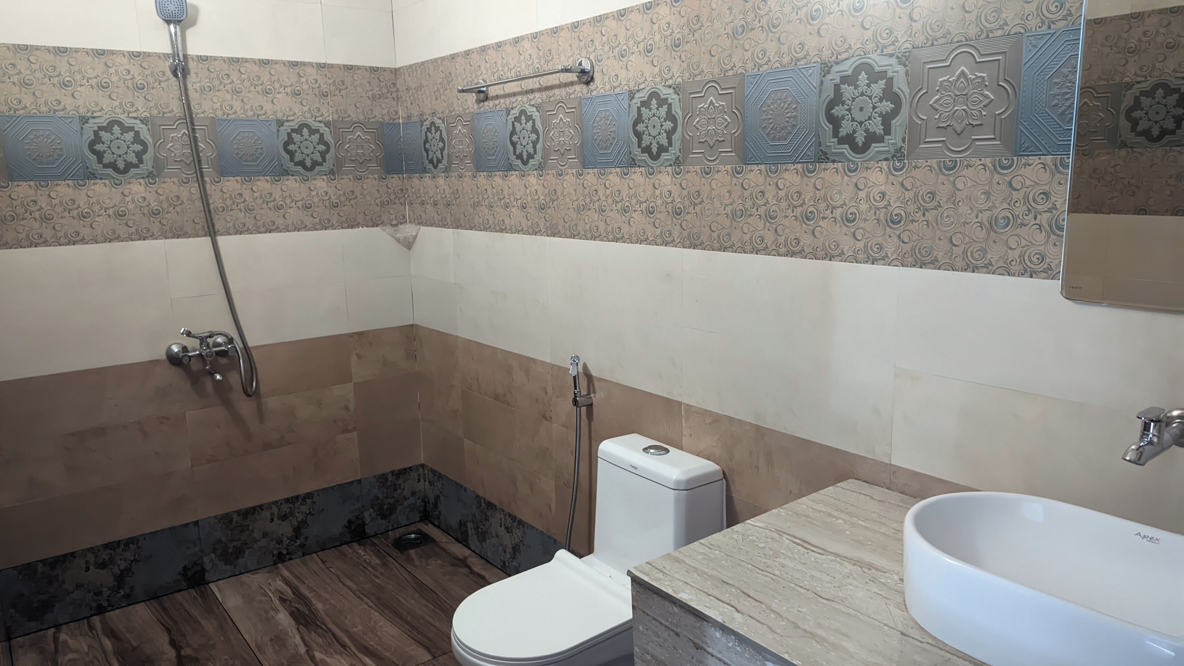 A bathroom with a shower, toilet, and sink.