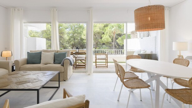 A spacious living room with a sofa, coffee table, and dining area. - Isabel Apartment - Golden Mile (Marbella)