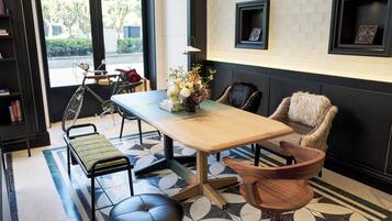 A modern interior with a wooden table, chairs, a bench, and a patterned floor.