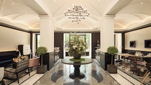 A spacious lobby with a central round table, a chandelier, and a large window. - OPARTMENT The Far Eastern Hotel - People's Square (Shanghai)