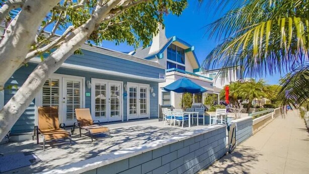 A beachfront property with a covered patio, outdoor seating, and a view of the ocean. - South Mission Beach Gem, Steps to Bay, Dual Patios (San Diego)