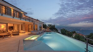 A modern house with a swimming pool, outdoor seating, and a scenic view. - Luxury Villa Dana Indoor Pool and Sauna (Matulji)