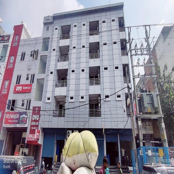A multi-story building with several balconies and a mix of commercial and residential spaces. - Hotel SK Residency  (New Delhi)