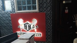 A room with a billiards table, a window with patterned curtains, and a door labeled "PRADA". - Tega Suites Ikeja (Lagos)