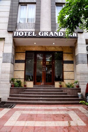 A hotel entrance with a sign reading "HOTEL GRAND". - Hotel Grand Inn  (Ghaziabad)