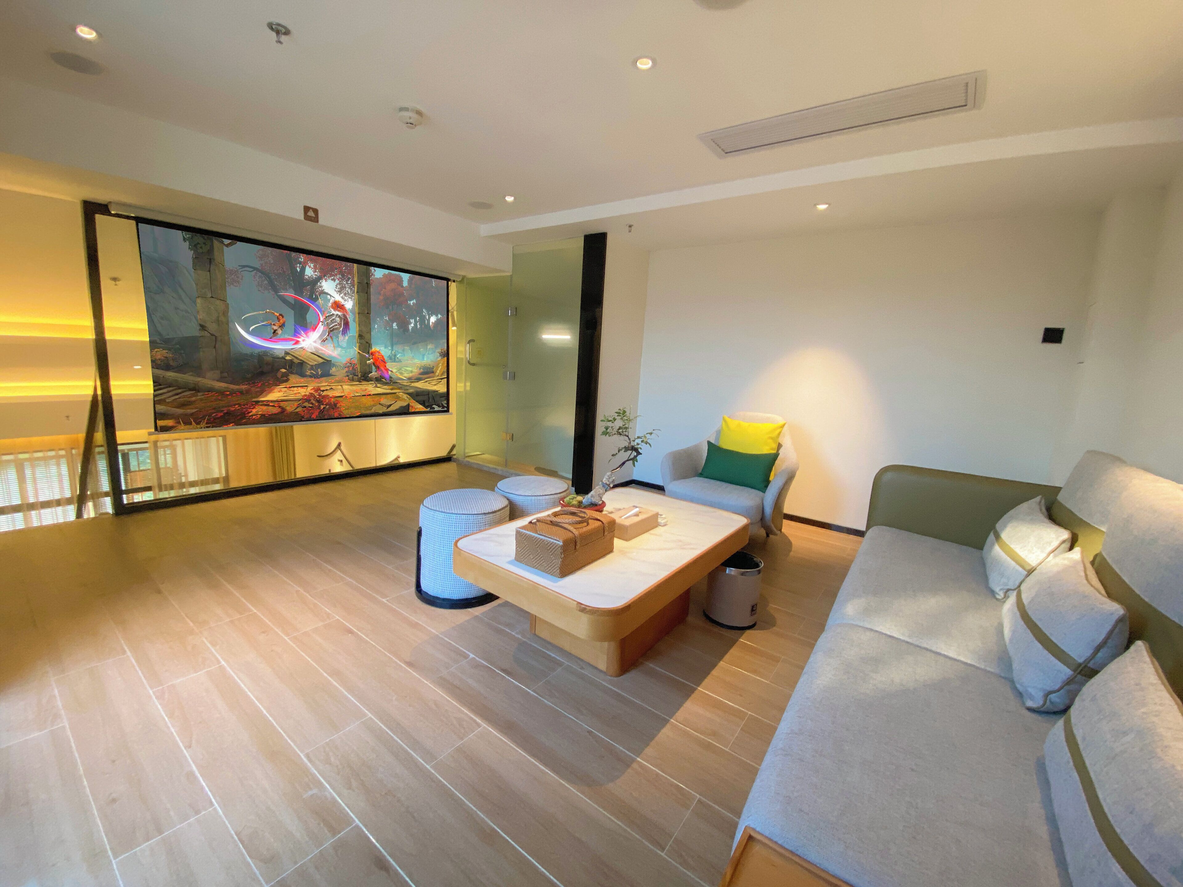 A modern living room with a large aquarium, a sofa, and a coffee table.