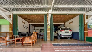 A covered parking area with a white SUV parked inside.