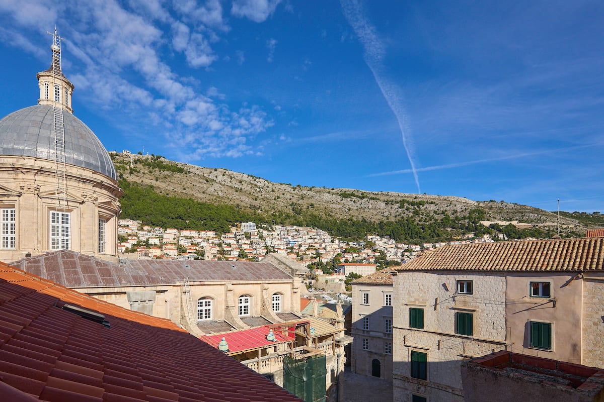 A historic town with a prominent dome and terracotta-roofed buildings.