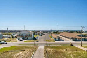 A residential area with houses, a parking lot, and a clear sky.