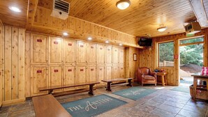 A wooden cabin interior with lockers, benches, and a view of the outdoors. - AN124 | Antlers Steamboat | Close to Base | A/C | Ski In/Out (Steamboat Springs)