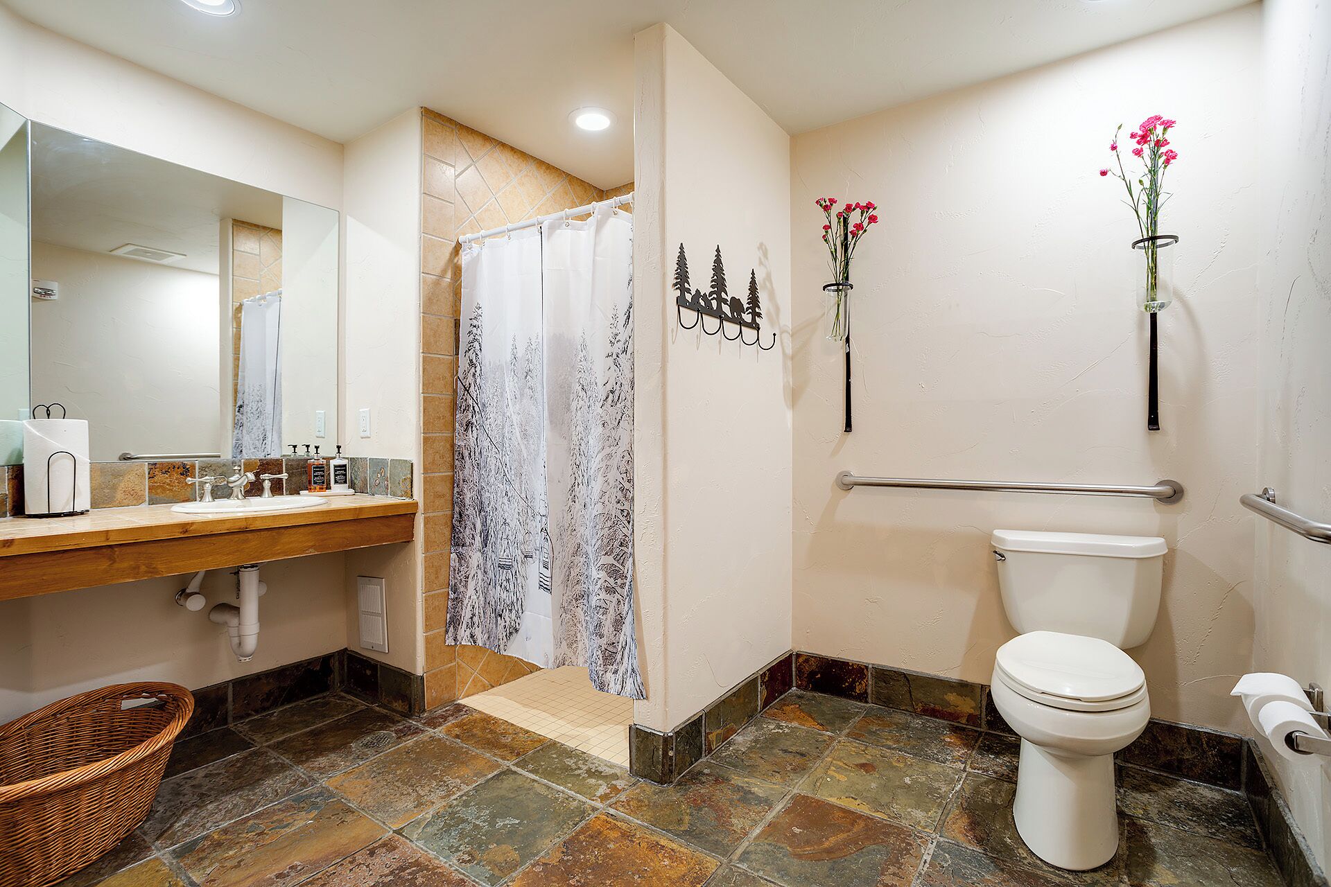 A bathroom with a shower, toilet, and sink.