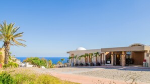 A hotel with a modern design, a dome structure, and a view of the sea. - Pedregal Luxury Villa w/ Infinity Pool, Hot Tub, Walk to Beach & Sunrise Views (Cabo San Lucas)