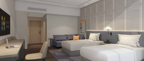A modern hotel room with a desk, two beds, a sofa, and a patterned rug.