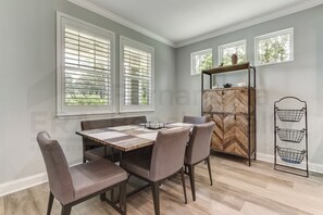 Enjoy meals in this cozy dining area with a rectangular table and comfortable chairs.