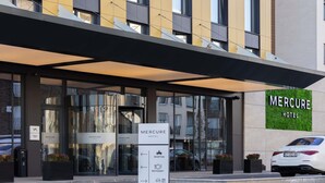 Ein Hotel Eingang mit Schild, das eine Rezeption, ein Restaurant und Parkplätze anzeigt.