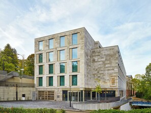 A modern building with a stone facade, multiple windows, and a sign reading 'TRIBE'. - Tribe Baden Baden (Baden-Baden)