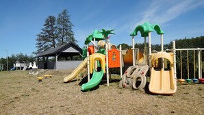 A playground with slides and climbing structures.