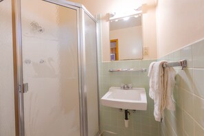 Family Room, 2 Queen Beds, Kitchenette | Bathroom | Shower, free toiletries, hair dryer, towels