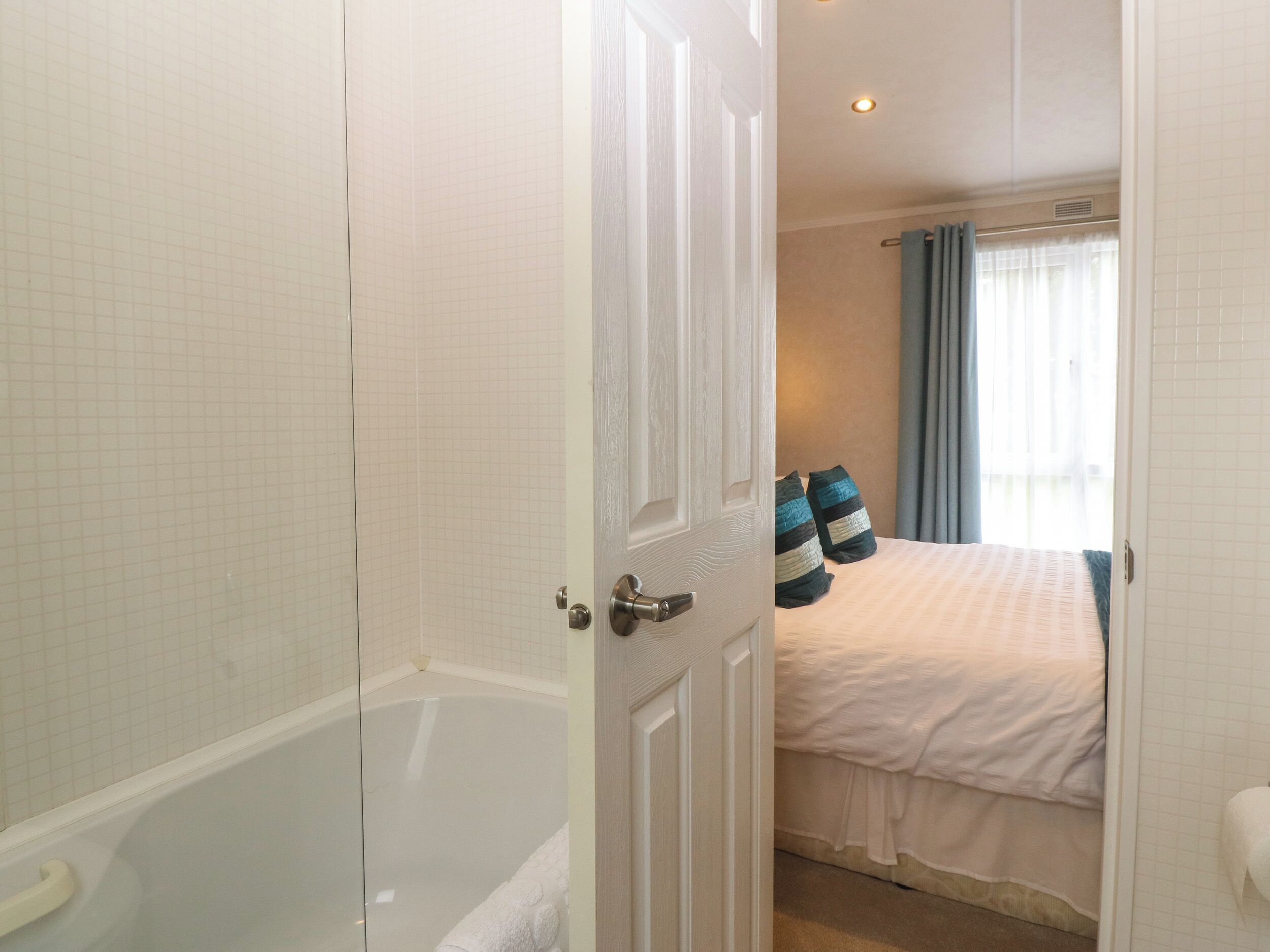 A bathroom with a bathtub, a toilet, and a shower area.