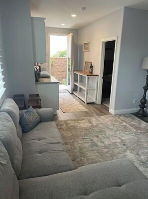 Relax in this stylish living area with a plush sofa, coffee table, and cozy rug.