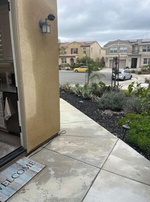 Guests enter through a welcoming entrance area with a tiled floor and a comfortable mat.