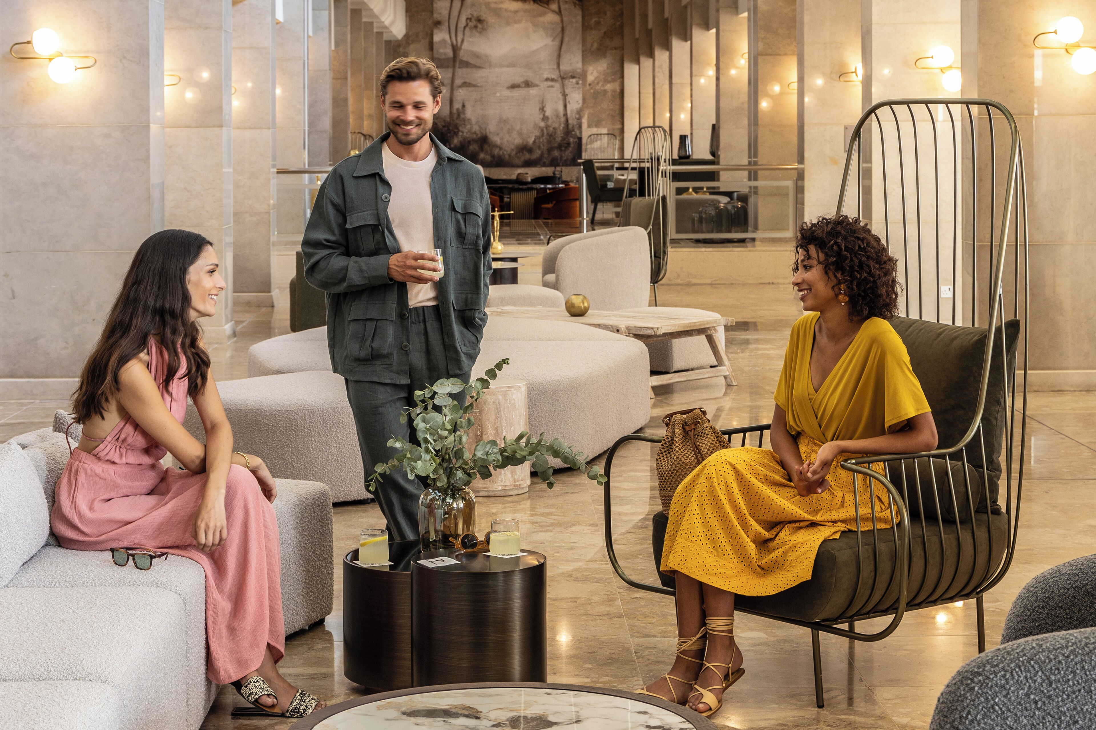 A modern lounge area with seating arrangements, a coffee table, and a decorative vase.