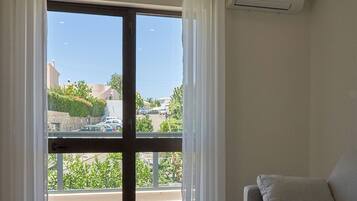 Deluxe Apartment | Living area | 20-inch flat-screen TV with cable channels