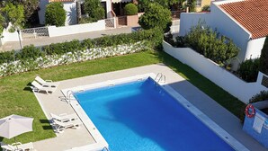 A rectangular swimming pool with a tiled deck and a small adjacent pool. - LEGACY SUITES & APARTMENTS ALBUFEIRA AL (Albufeira)