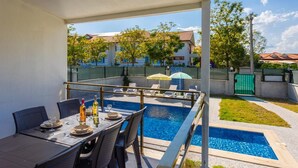 A covered outdoor area with a pool, dining table, and chairs. - Villa Sasha 3 - Four Bedroom Villa, Sleeps 10 (Ortaca)
