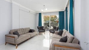 A modern living room with two sofas, a coffee table, and a chair. The room has large windows with blue curtains and a view of the outside. - Villa Sasha 2 - Four Bedroom Villa, Sleeps 10 (Ortaca)