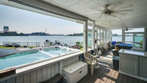 A deck with a hot tub, outdoor seating, and a view of a lake. - Weymouth Waterfront Getaway w/ Swim Spa & Hot Tub (Weymouth)