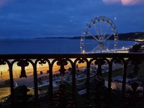 A Ferris wheel at dusk with a view of the sea and a cityscape in the background. - The Seahome (Scarborough)