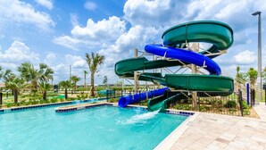 A water park with multiple slides and a pool. - Storey Lake 9 BR Themed Games Room (Kissimmee)