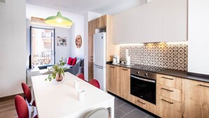 A modern kitchen with wooden cabinets, a white countertop, and a patterned backsplash.