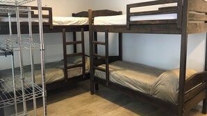 A bunk bed room with metal shelves and a ladder. - Colonial Hostel SP (São Paulo)