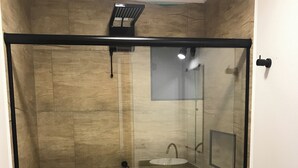 A glass-enclosed shower stall with a toilet and sink. - Colonial Hostel SP (São Paulo)
