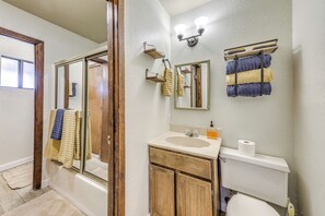 A bathroom with a wooden vanity, a sink, a toilet, and a glass shower enclosure. - Ruidoso Home w/ Balcony ~ 16 Mi to Ski Apache! (Ruidoso)