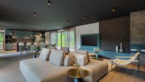 A modern living room with a sofa, a coffee table, and a TV wall. - VILA NICOL TIRELI premium and private Villa in Istria for your family vacation (Boljevići)