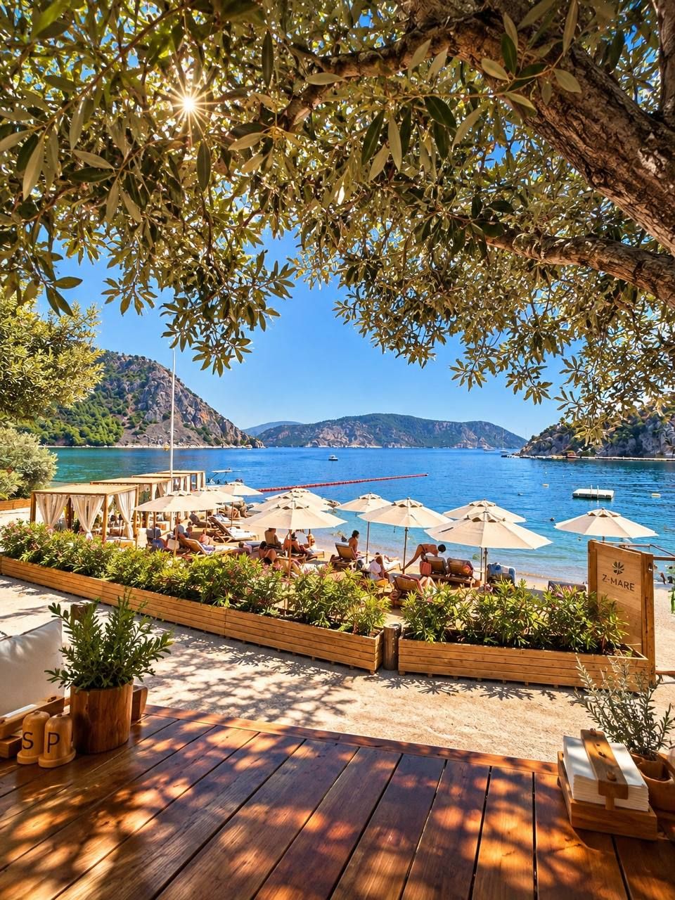 A wooden deck with outdoor seating and umbrellas overlooking a body of water with boats.