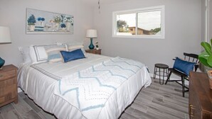 A bedroom with a bed, a ceiling fan, a window, and a painting on the wall. - Fallbrook's Finest Hideaway Casa - Pool, Game Rm (Fallbrook)