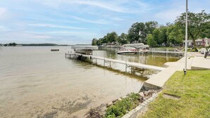 A calm lake with a dock extending into the water.