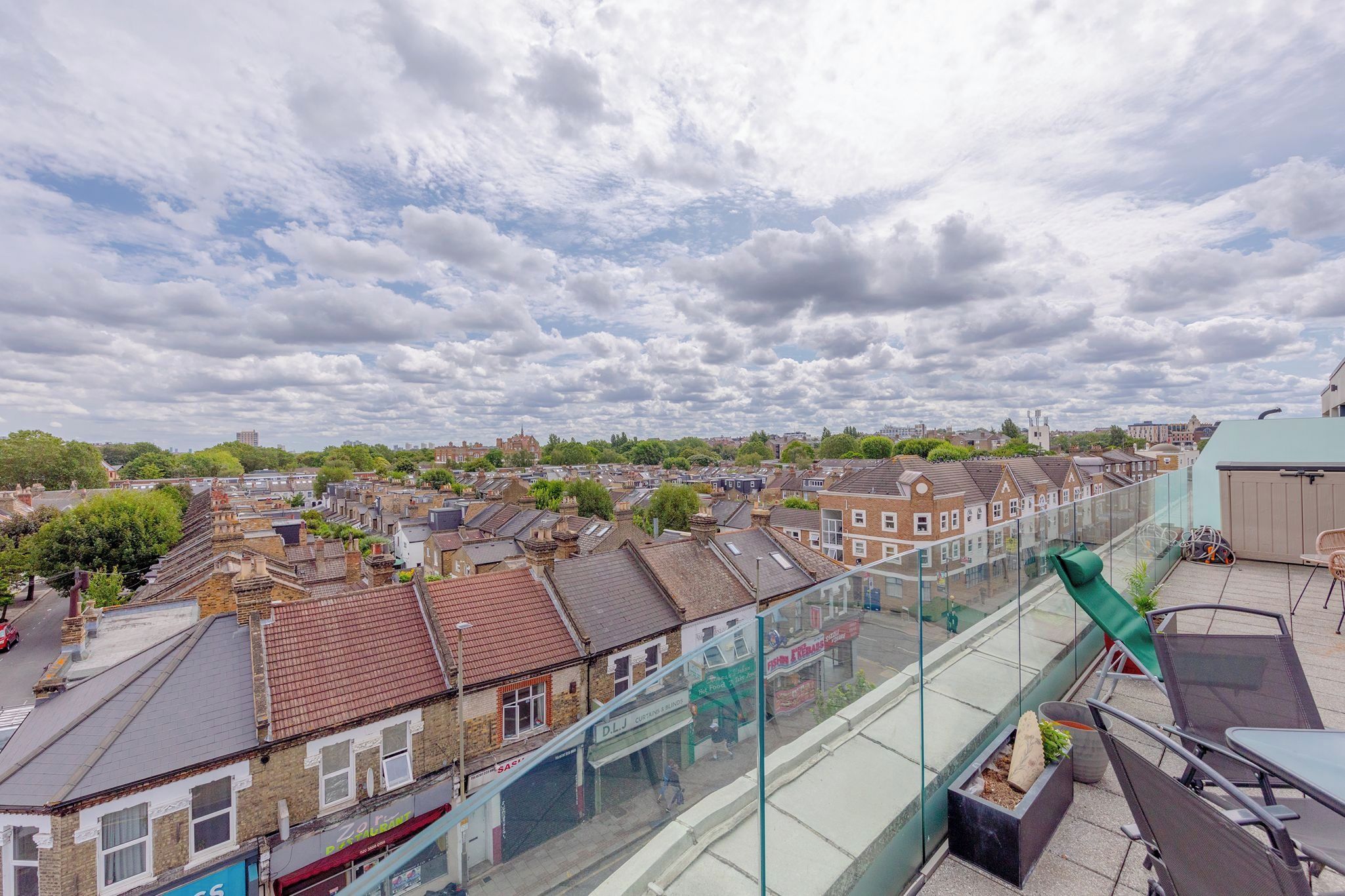 A residential area with terraced houses and a clear sky.