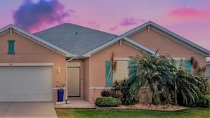A single-story house with a garage, a front door, and a small porch. - South Gulf Cove 4BR/2BA Heated Pool ,15 mins to the GULF (Port Charlotte)