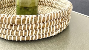 A green candle in a woven tray on a table. - Chic & central studio in the northern sunburns of Athens  (Agia Paraskevi)